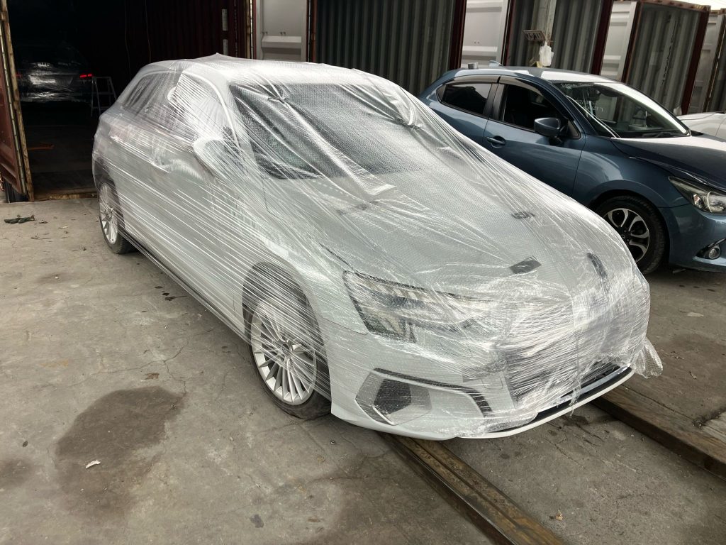 TokyoCarZ - wrapped Audi ready for import through container shipping