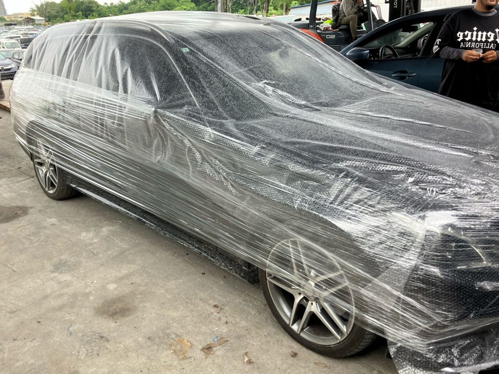 TokyoCarZ - wrapped Mercedes BenZ ready for import through container shipping
